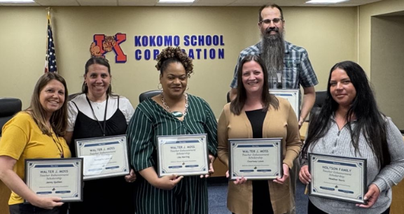 Group of educators holding certificates after earning scholarship grants