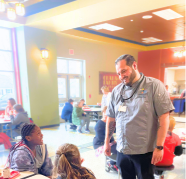School Cafeteria staff member talking to students