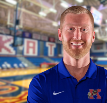 Male coach smiling gym background