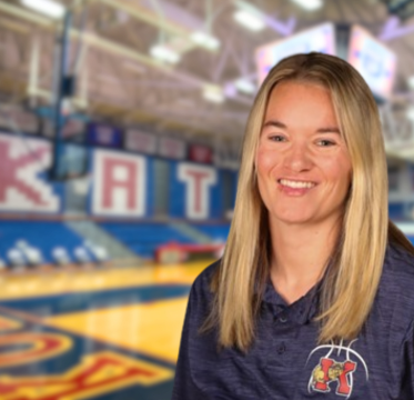 Female coach smiling gym background