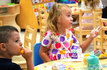 boy and girl eating breakfast at school