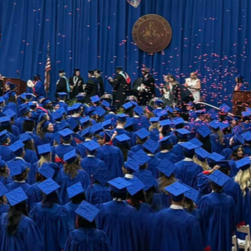 graduating students in caps and gowns confetti