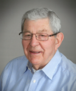 Smiling older man wearing glasses and professional attire
