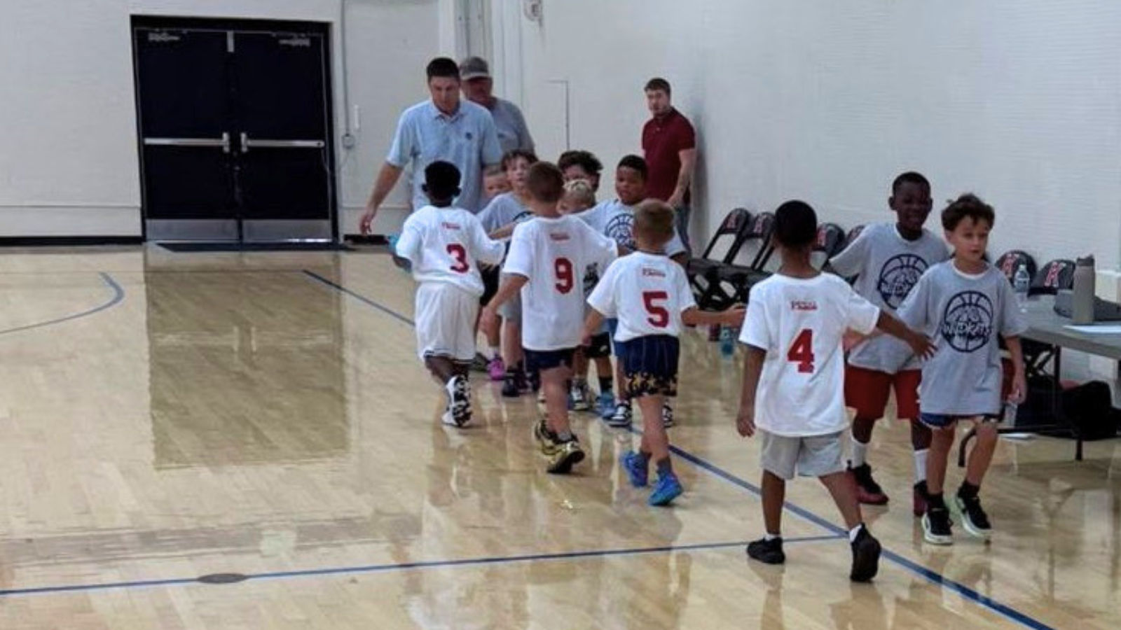 youth boy basketball teams giving each other high-fives