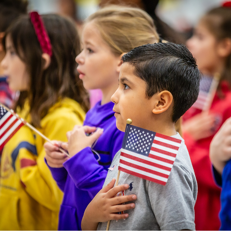 Student holding a small American flag