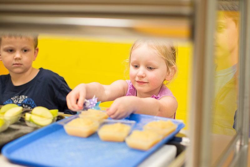 Bennett Elementary students going through their cafeteria lunch line.