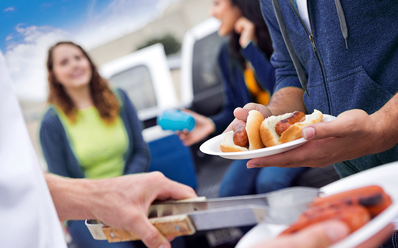 tailgaters enjoying some hot dogs