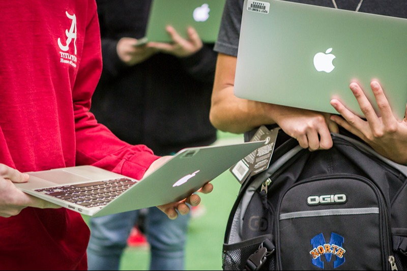 students with their district issued laptop