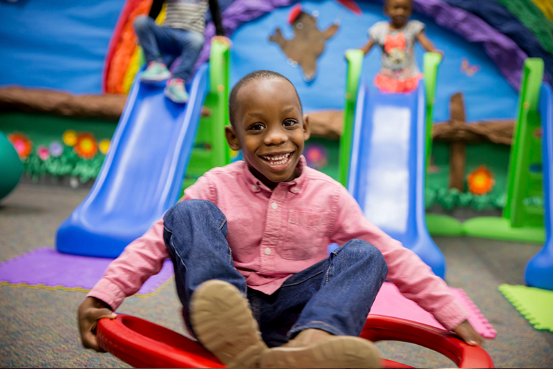 student having fun on rocking toy