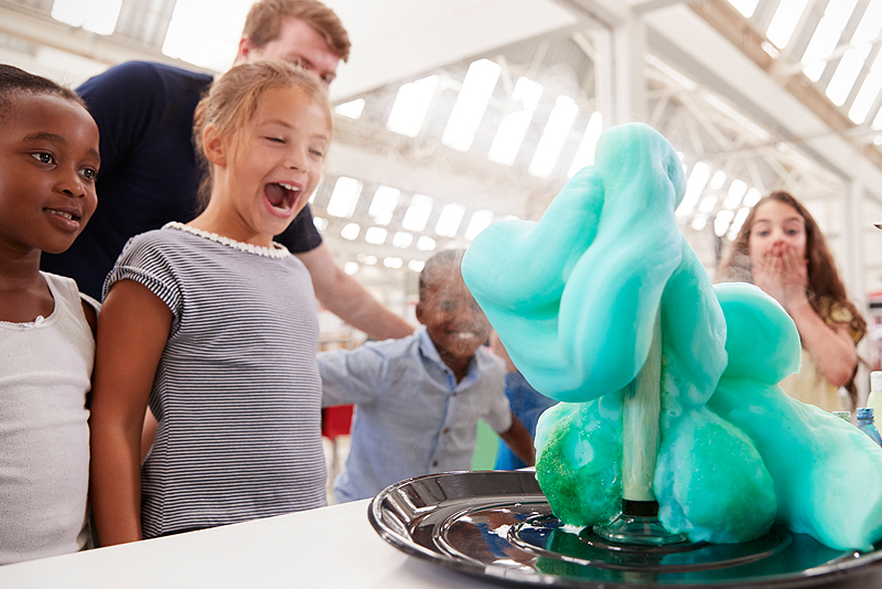 girl looking at a science experiment