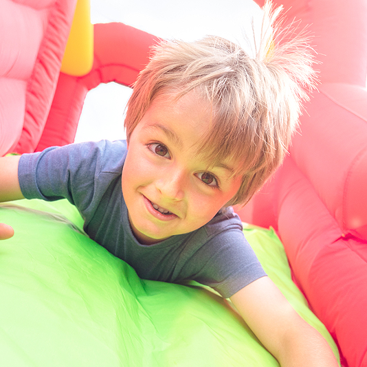 student on playground slide