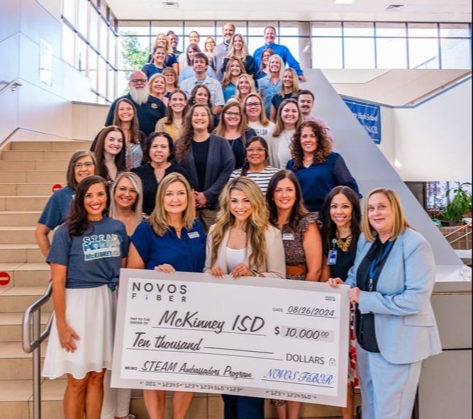 misd staff standing behind a large check