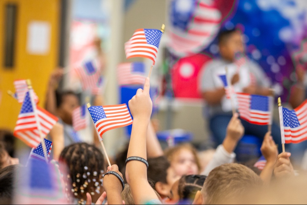 students holding American flags