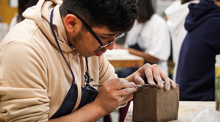 Student working with clay in art class