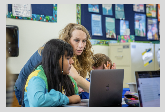 students working with a teacher