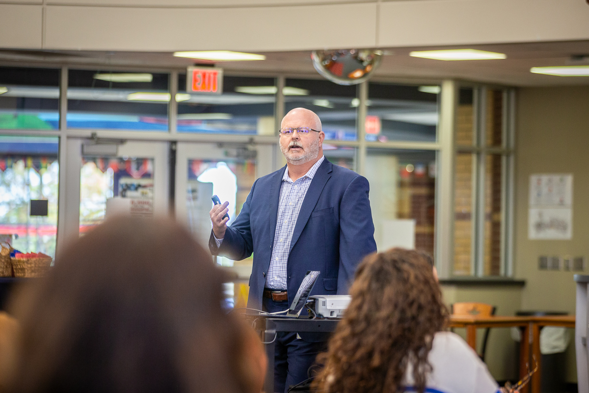 superintendent shawn pratt presents information  to the mckinney community action network
