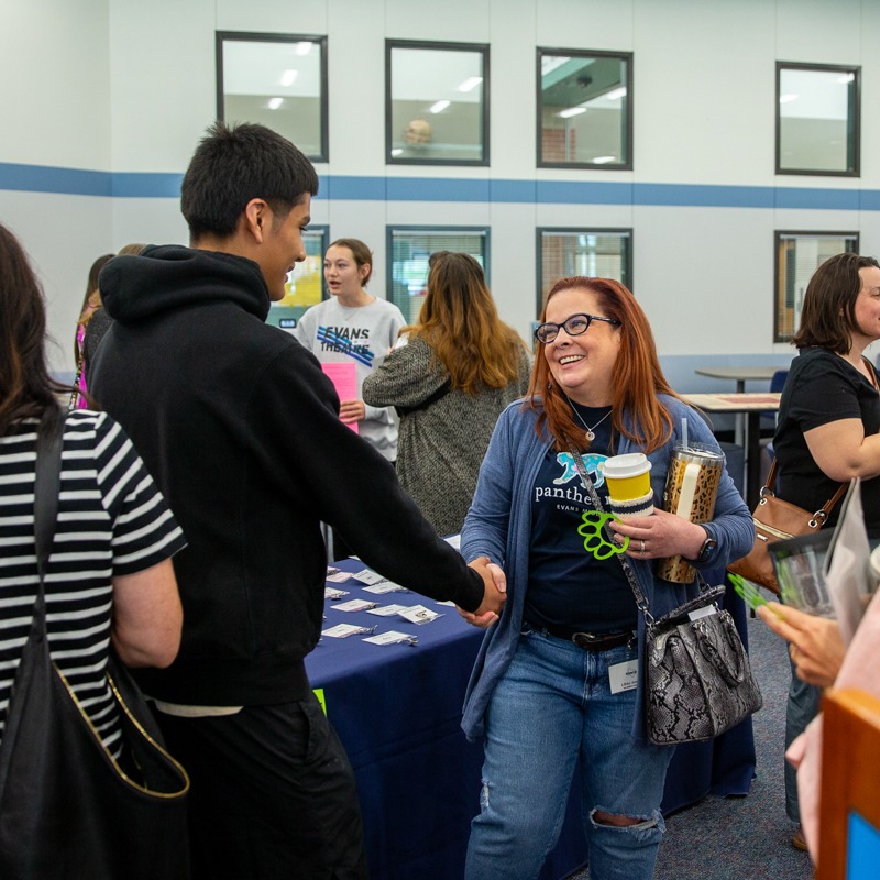 an evans middle school student greets a participant on the  mckinney community action network tour 