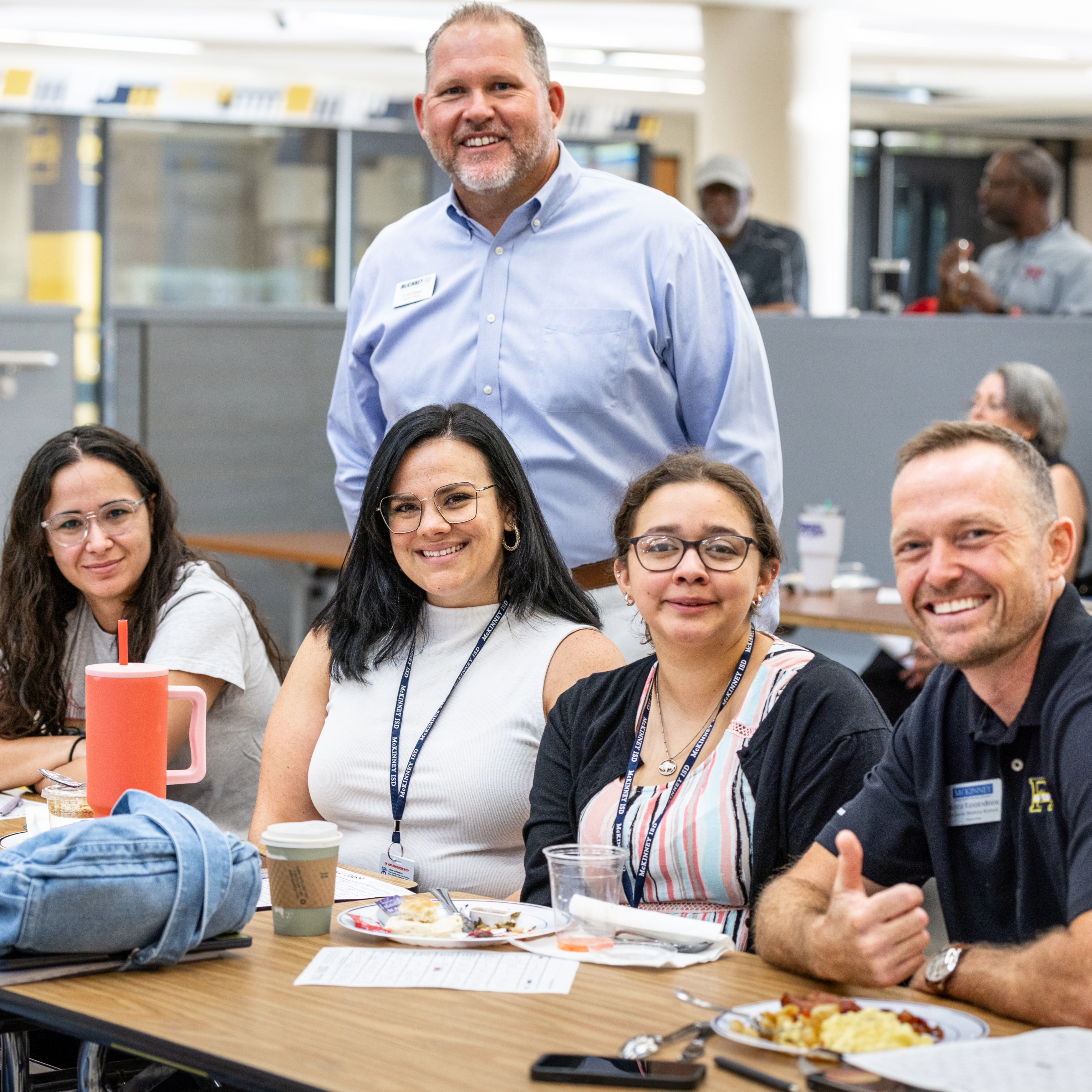 MISD board member corey homer takes a photo with new teachers at the new teacher breakfast 