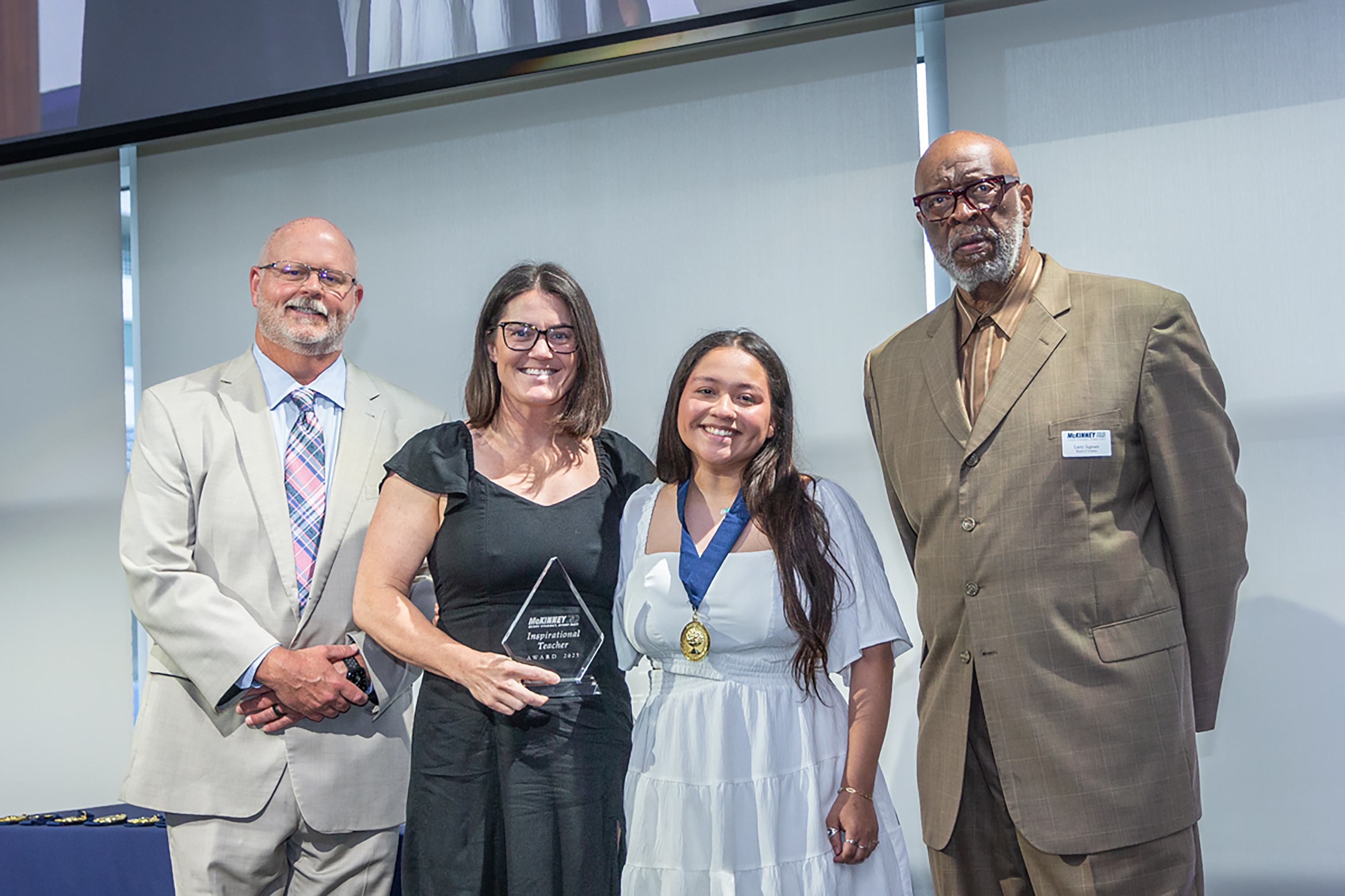 superintendent shawn pratt and board member larry jagours take a photo with a teacher and a student at the distinguished student awards 