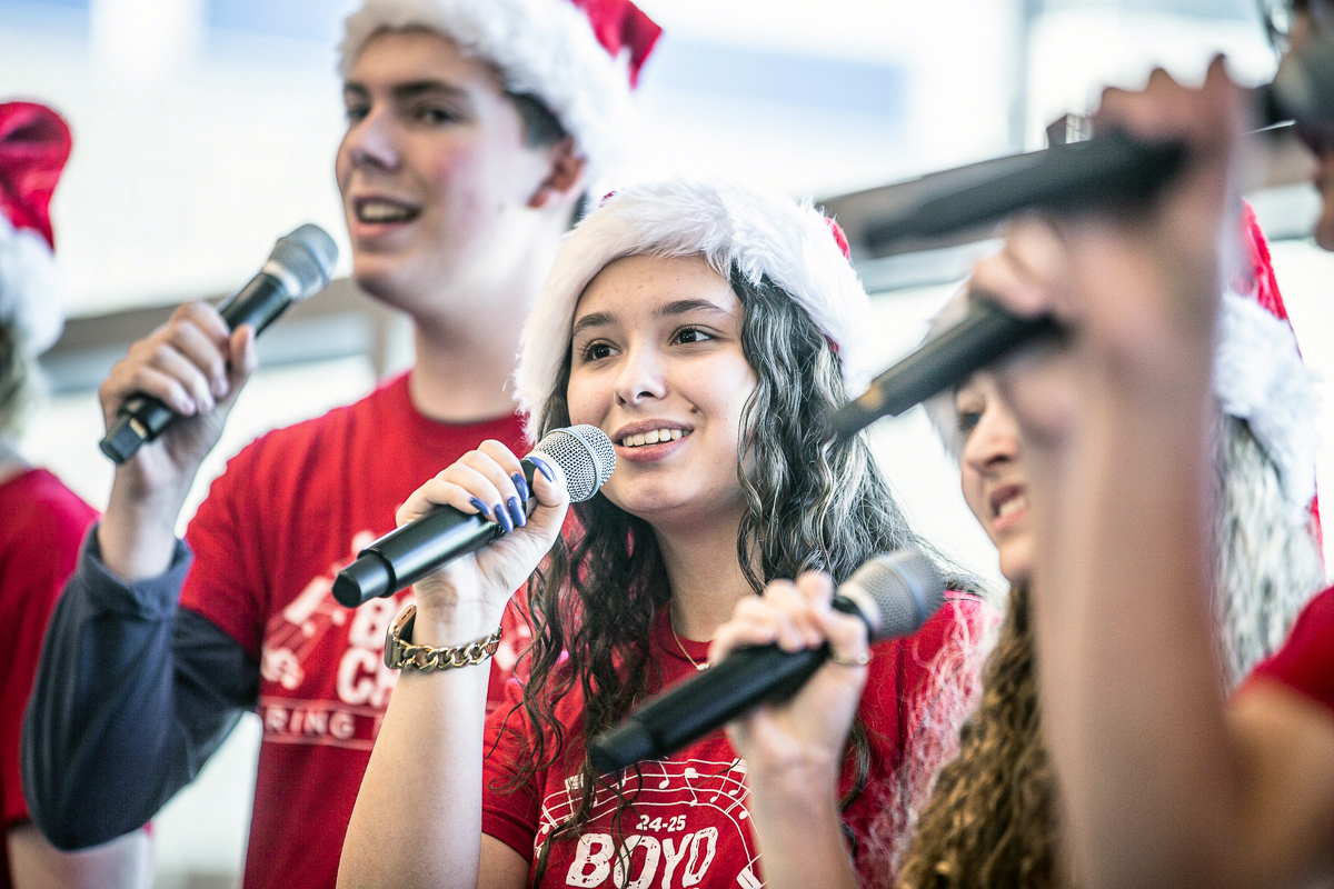 mckinney boyd high school students sing during a holiday event