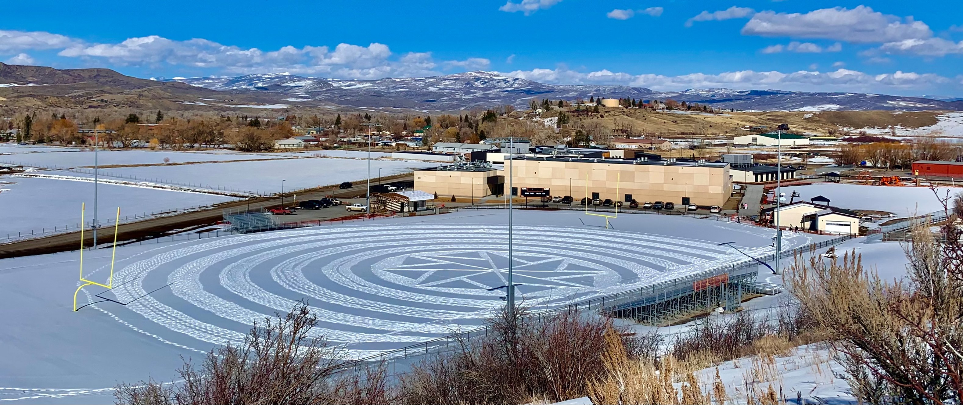 outdoor campus with snowy football field