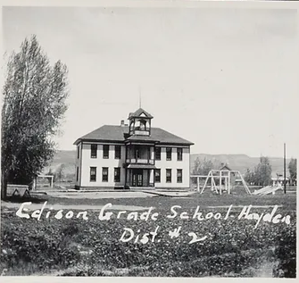 An old black and white photo of a school building, showcasing its historic charm and architectural elegance.