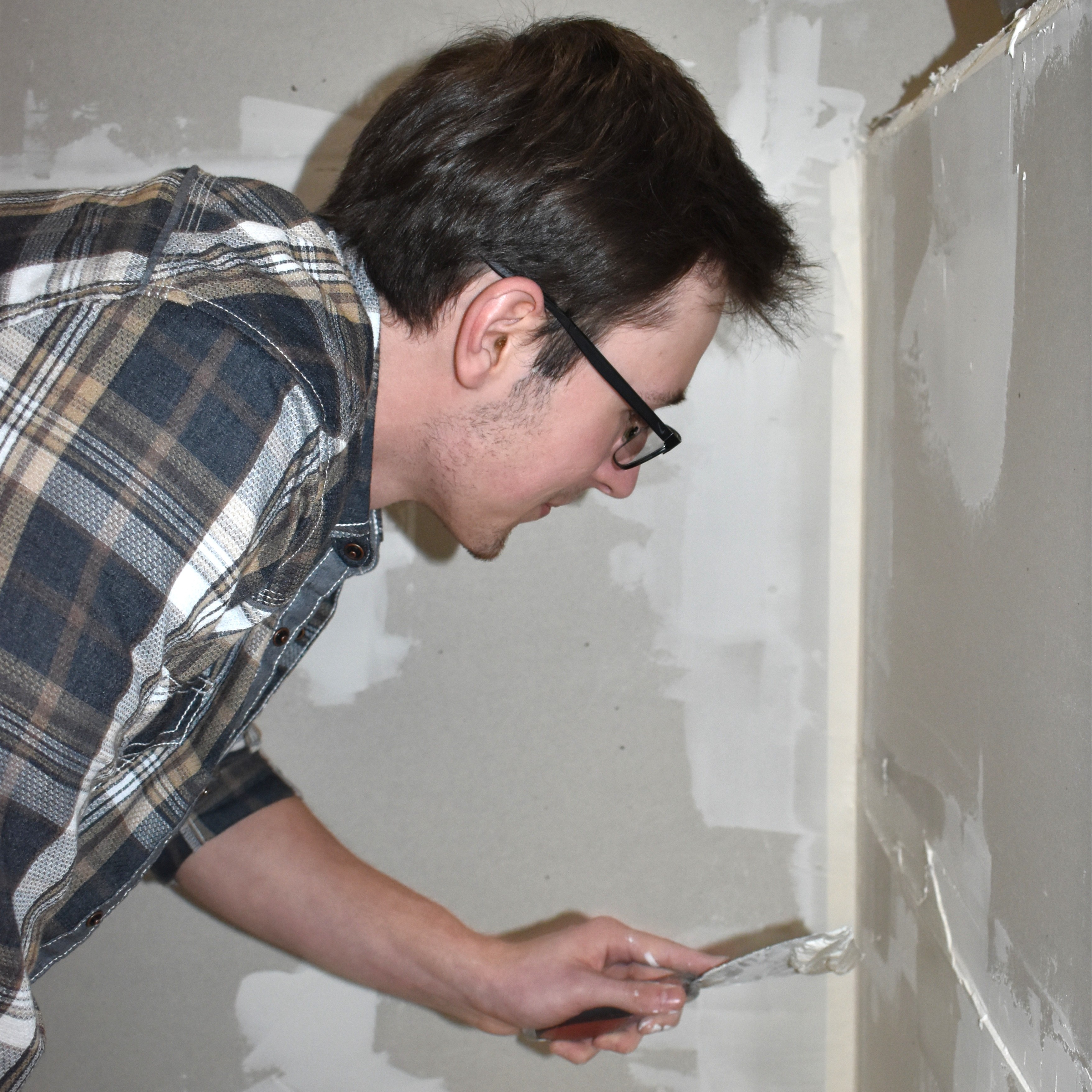 Student measuring block of wood