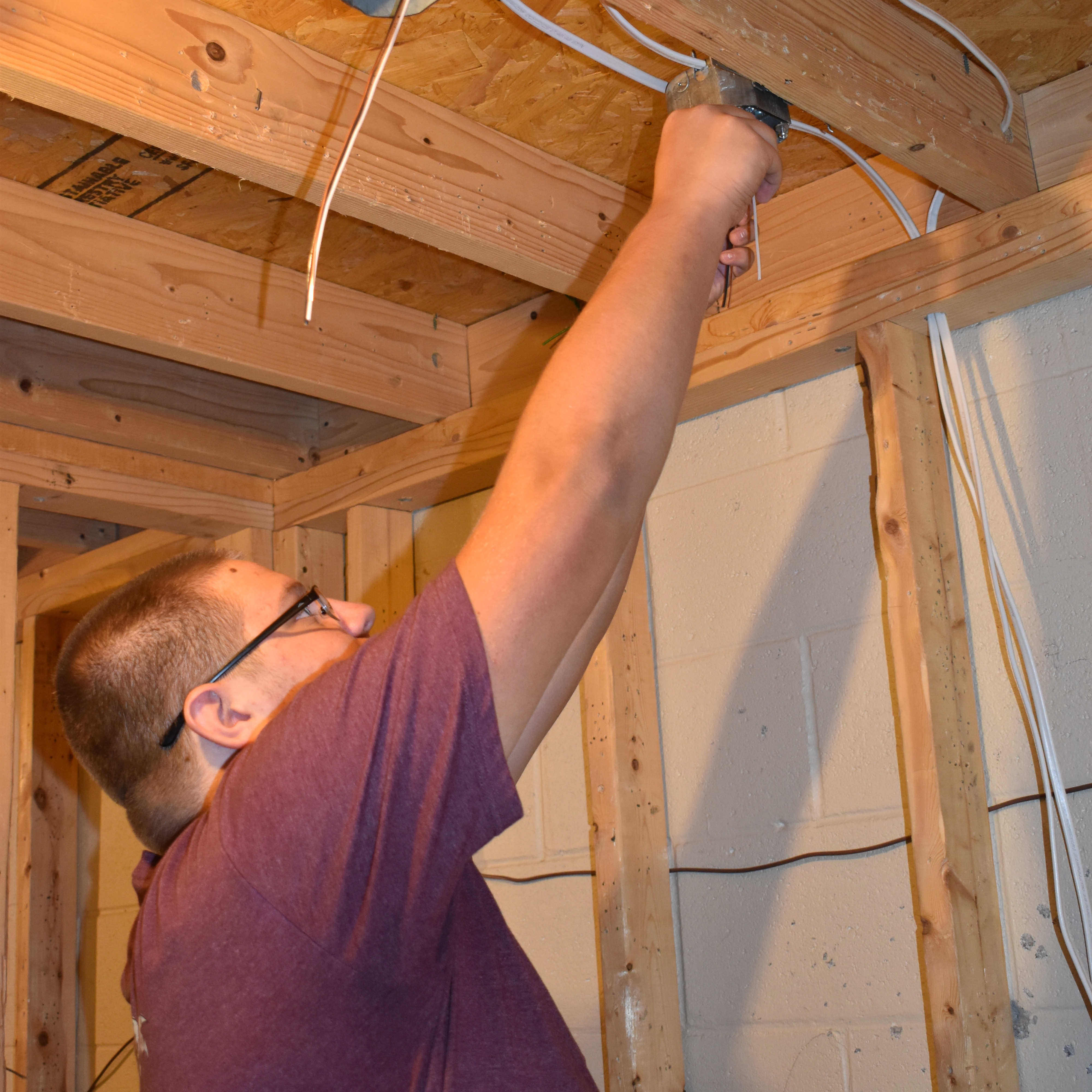student twisting the ground wire
