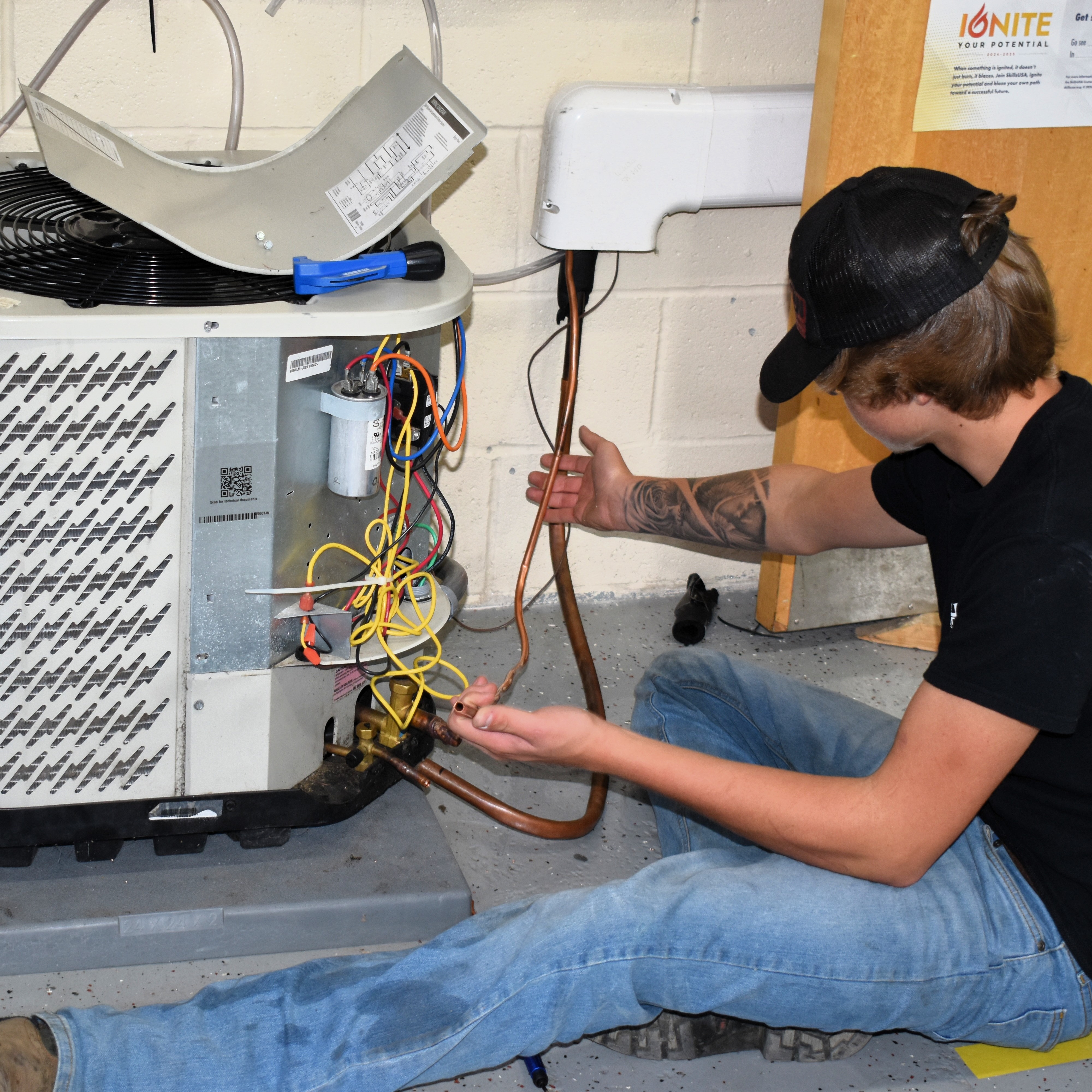 student working on AC unit