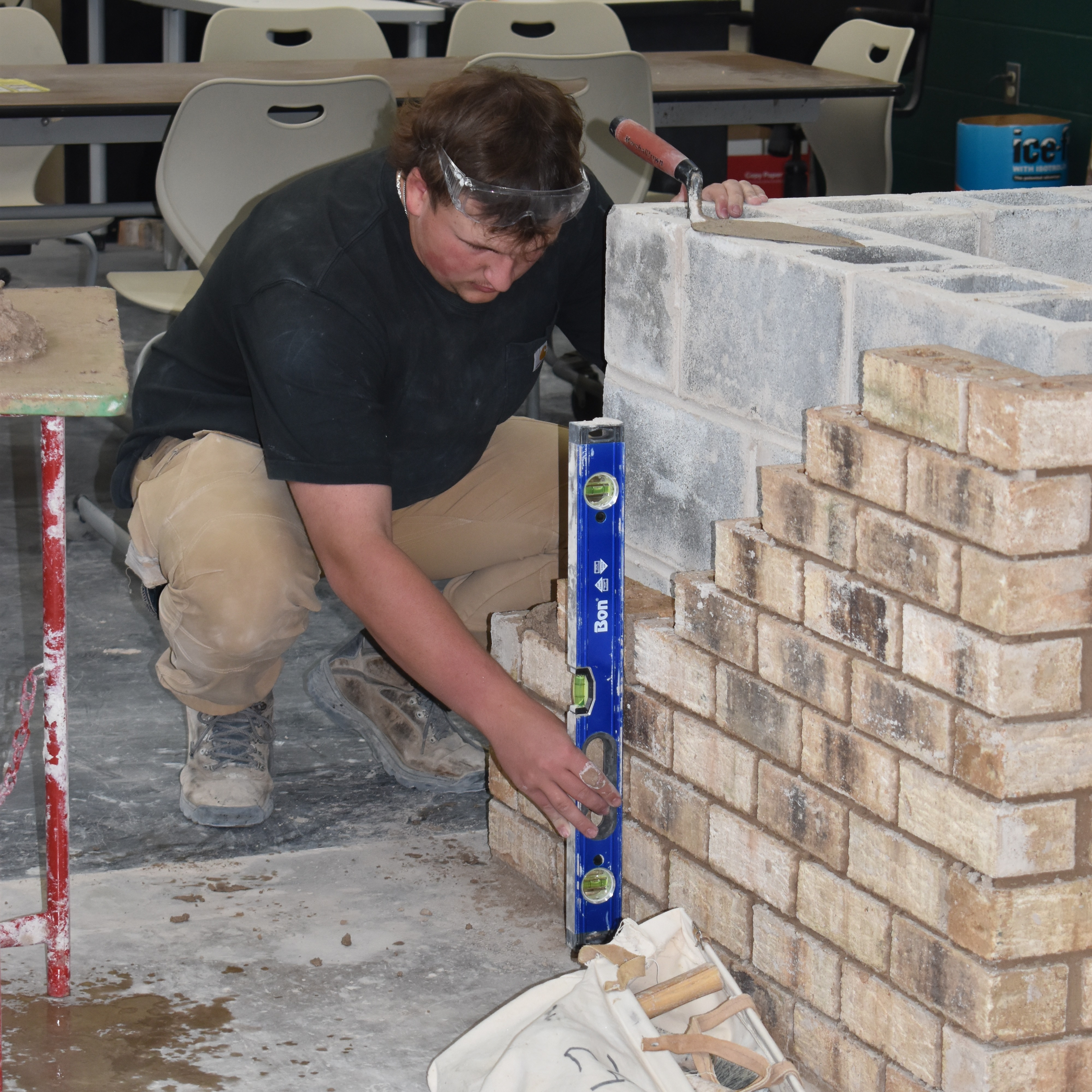 Student with a brick