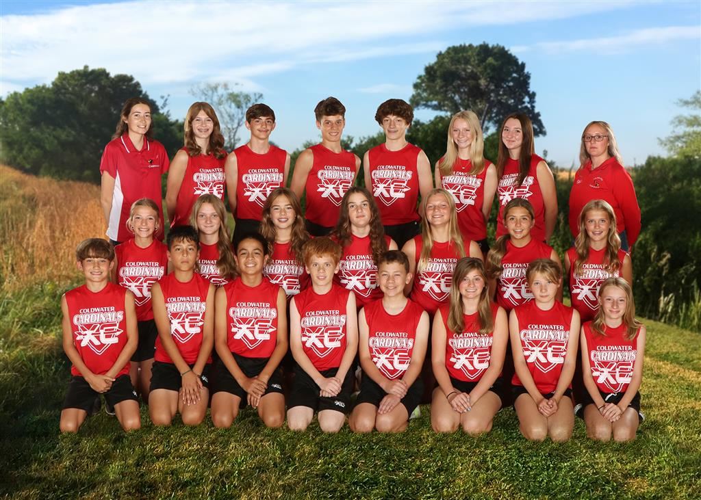The cross country team stands together, smiling, for a group photo.