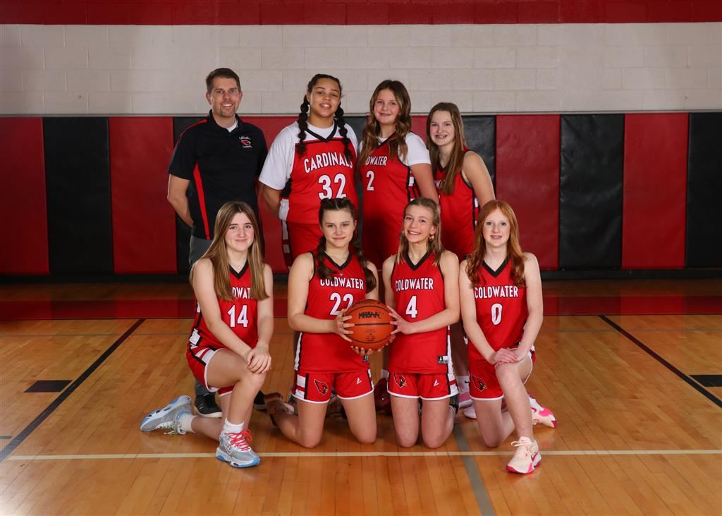 A photo of girls basketball players posing together for a group picture.