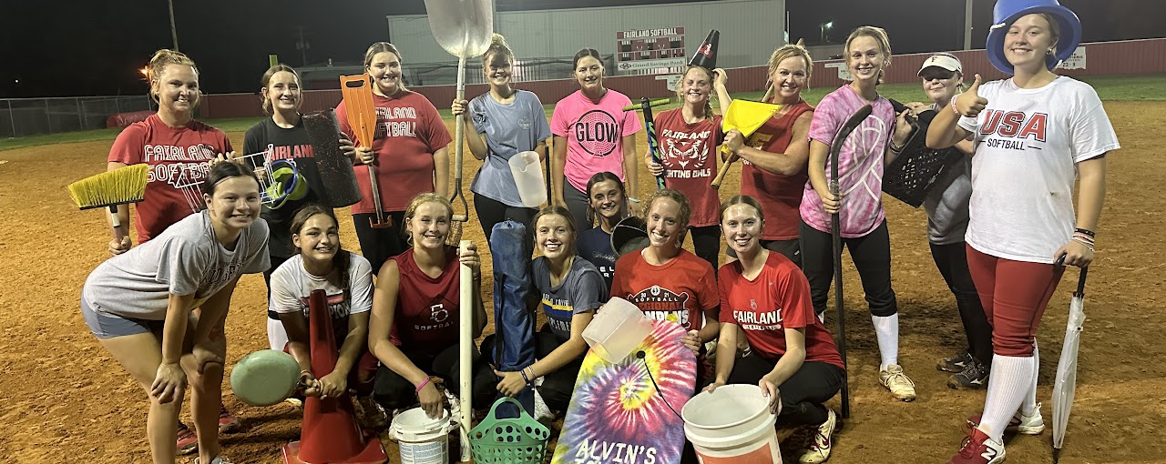 Fairland High School Softball Team while holding cleaning equipment.