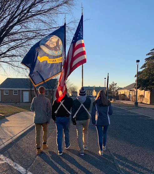 Students of Marine Academy of Science & Technology holding a Flag