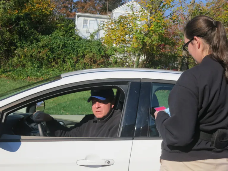 Someone talking to a person in a car