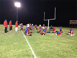 Foodball players by goal post