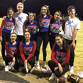 student cheerleaders gathered on the football field