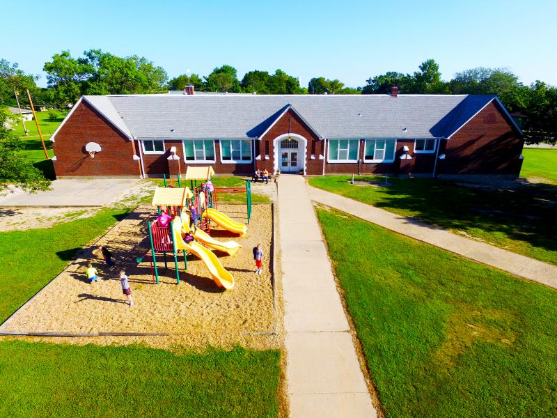 school building with playground in front