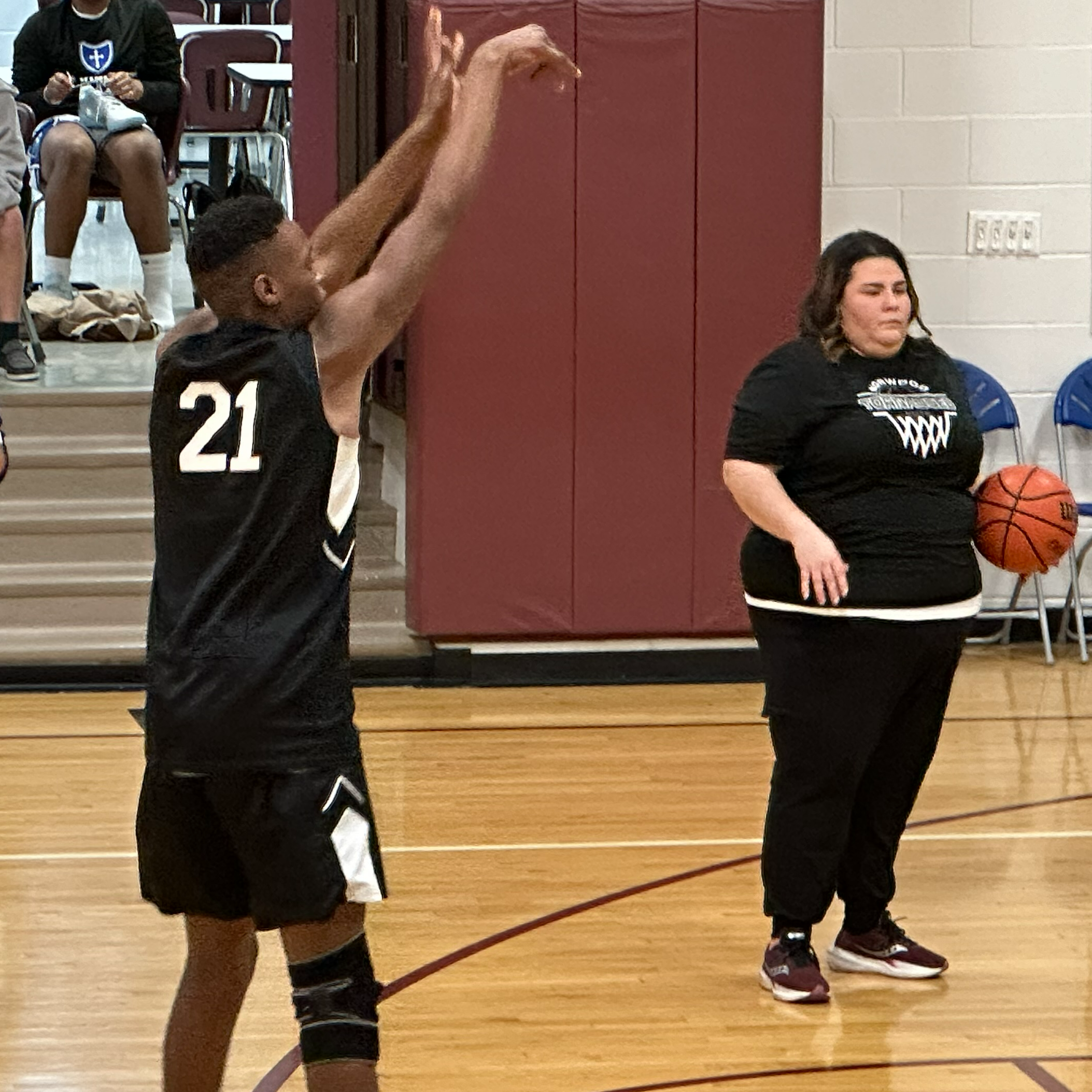 student and coach watching the game