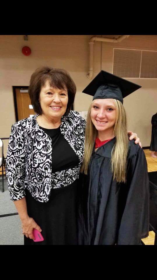 director and student hugging after graduation