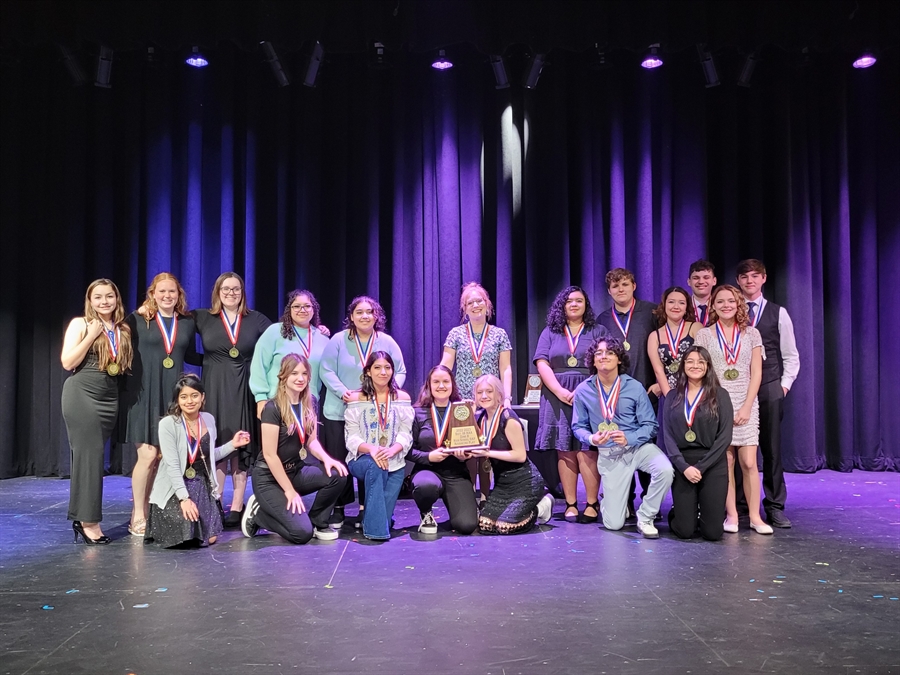 A group photo of the UIL actors holding their trophy and wearing their medals