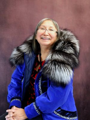 Image of a woman wearing a blue jacket with fur collar.