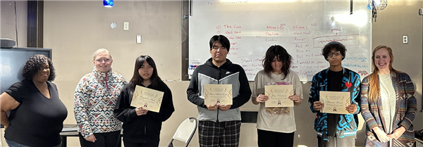 Students holding their diploma