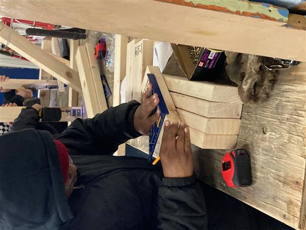 Measuring wood using a triangle ruler