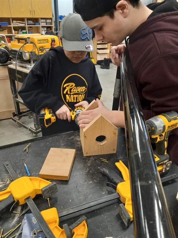 Students making a birdhouse