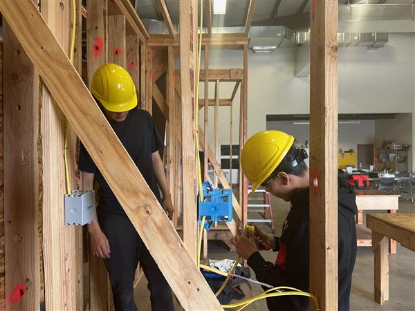 Two students working on electrical wires