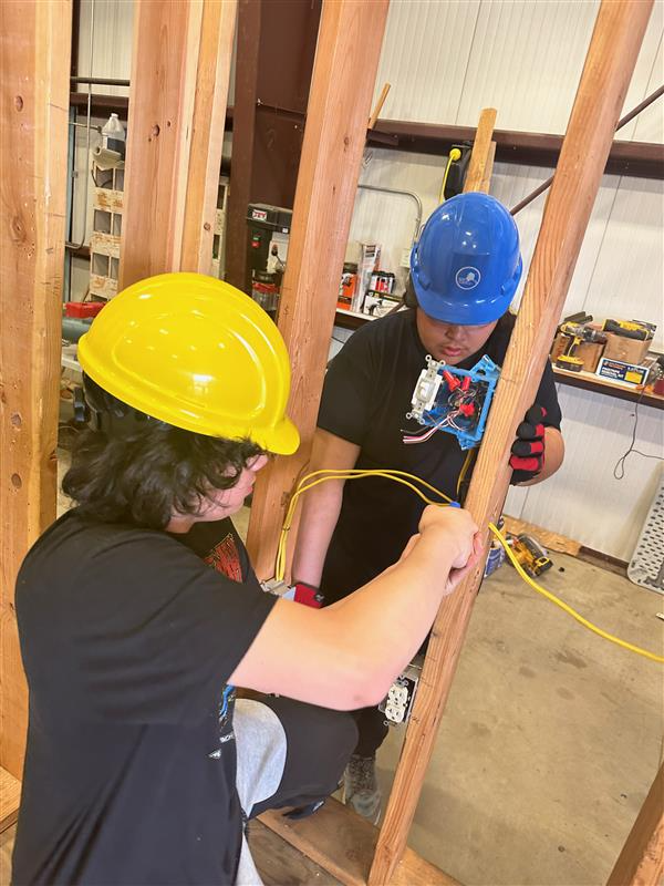 Student connecting electrical outlet 