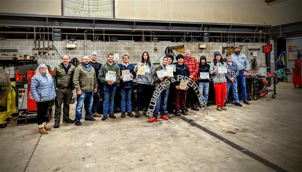 Students and teachers in the welding class