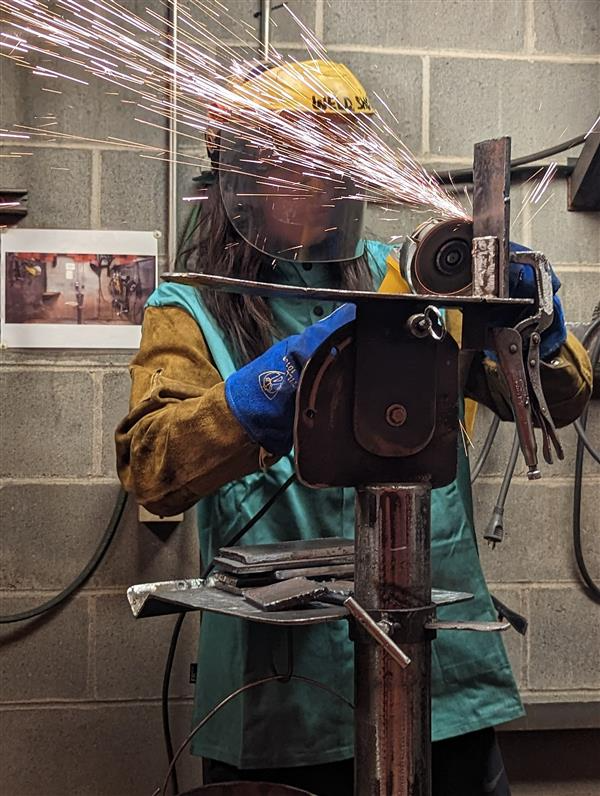 Student cutting iron