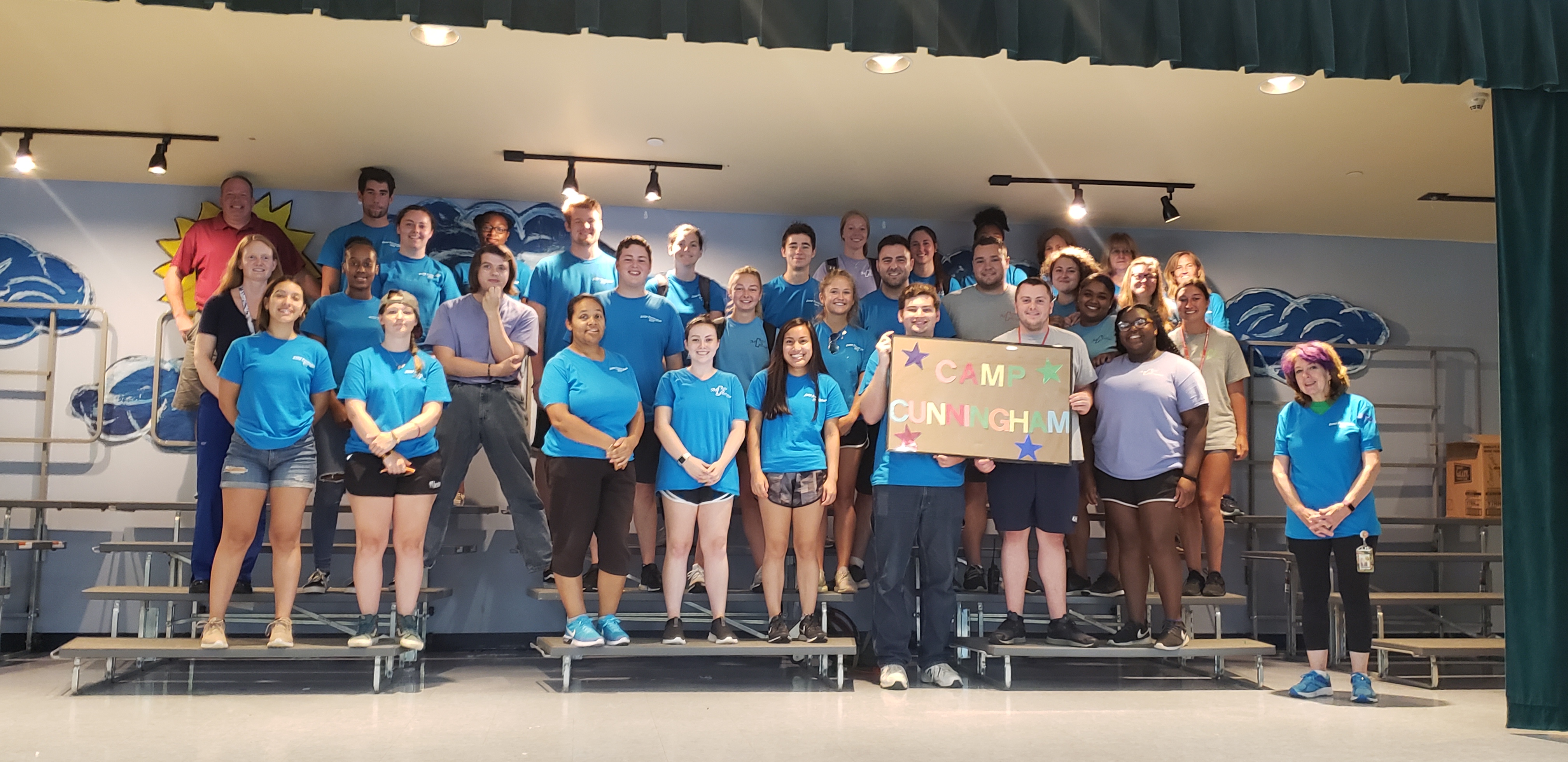 group of students posing on bleachers